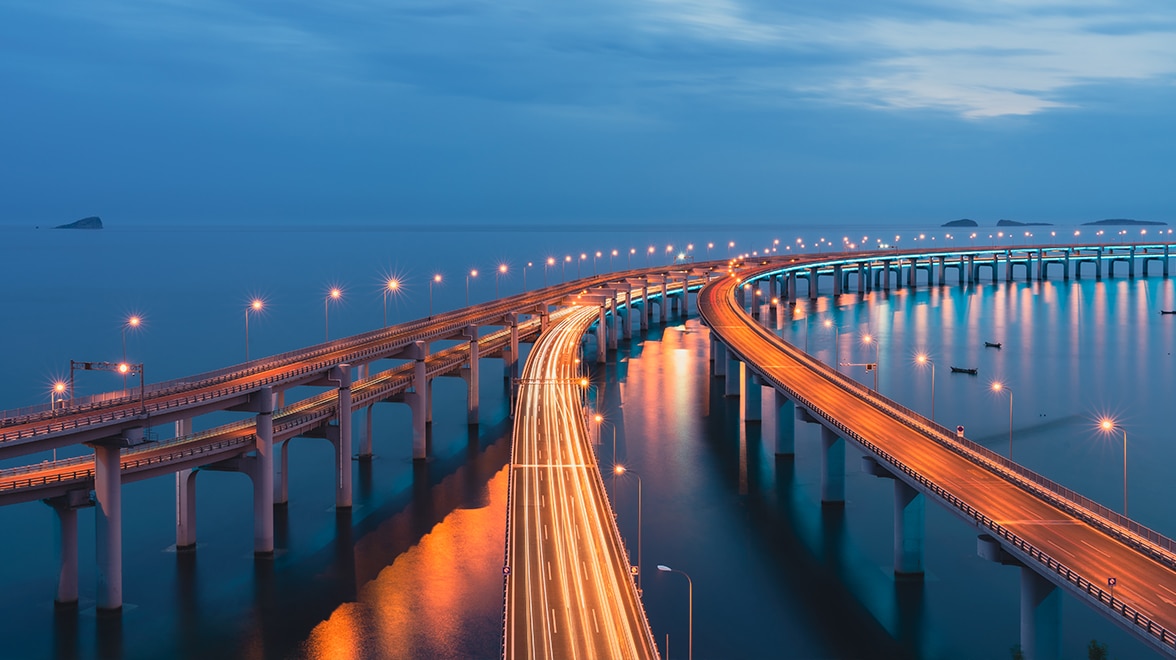 Bridge overwater at night with many lights.