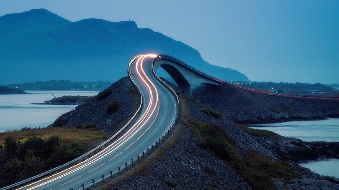 Road on a hill with lights moving fast.
