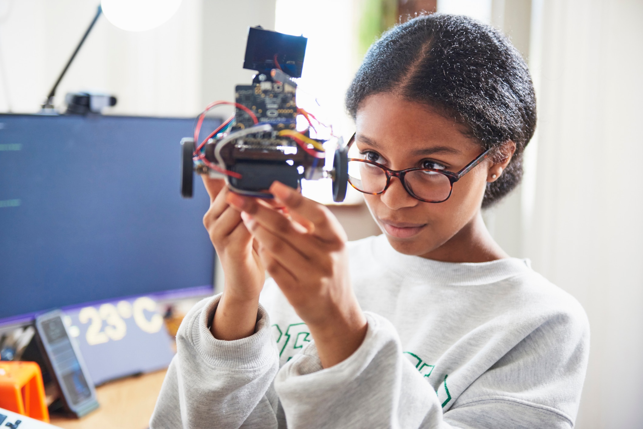 Girl looking at robotic car 