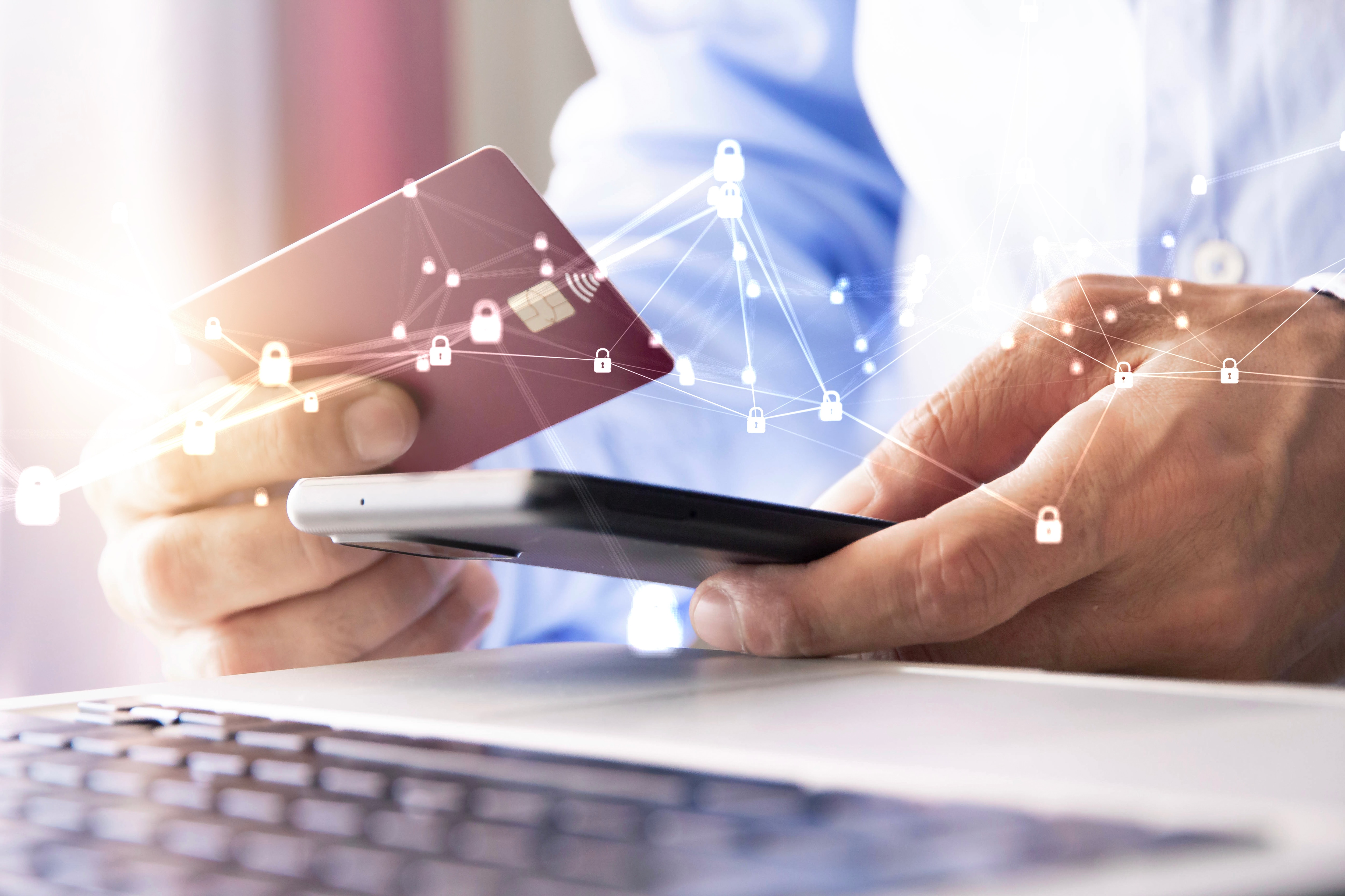 A person makes an online payment with a credit card and smartphone, with a network of digital security locks overlaid.