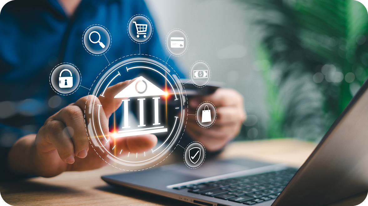 Digital banking interface showing a bank symbol surrounded by icons representing security, search, online shopping, card payments, and cash transactions, displayed over a laptop and mobile device.
